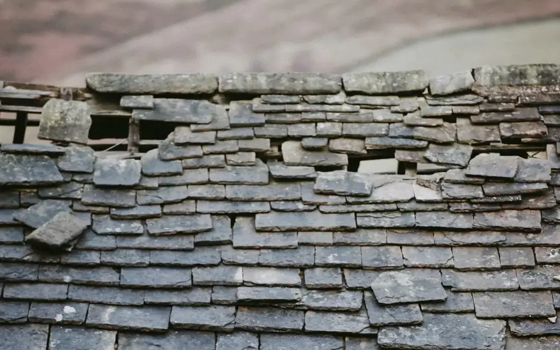 Slipped and missing slates after a storm, before repair