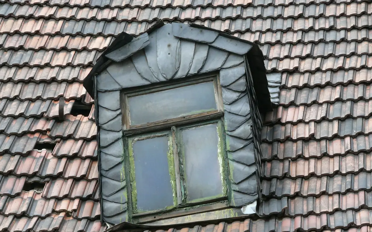 Lead-clad dormer window set into a clay tiled roof